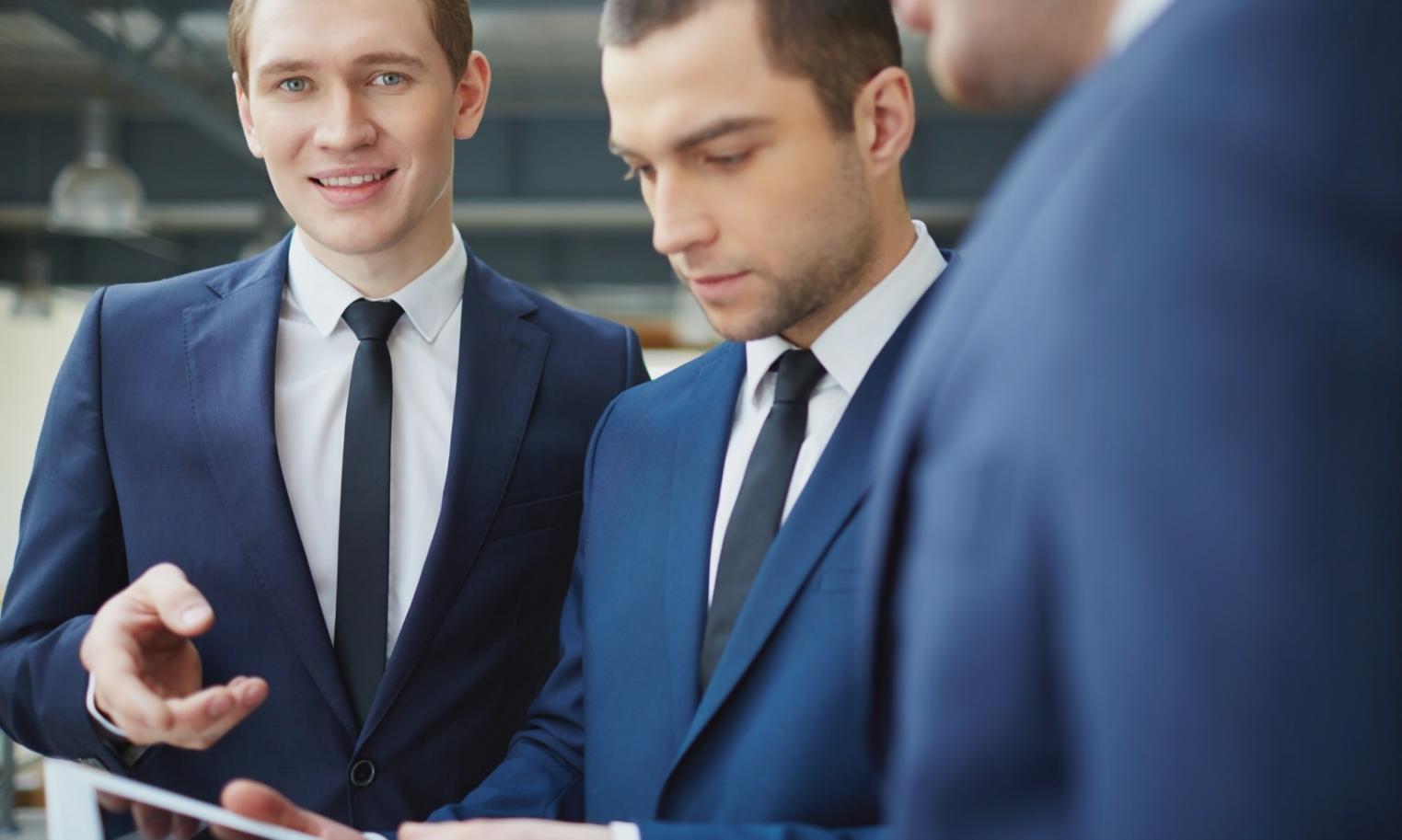Financial professional reviewing detailed budget deviation patterns on multiple screens
